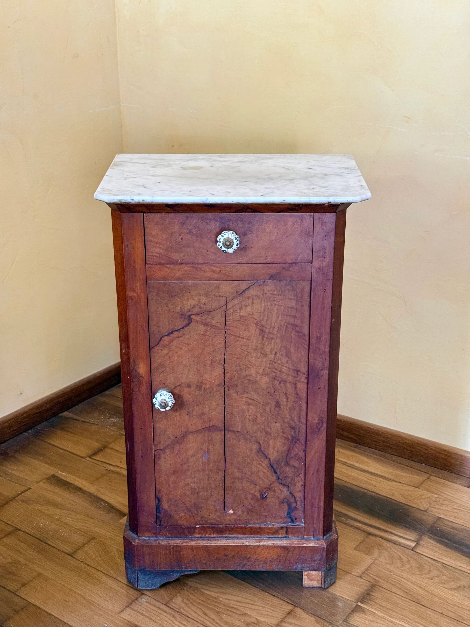 Wood and marble side table with ceramic handles.
