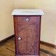 Wood and marble side table with ceramic handles.