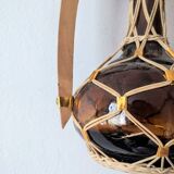 Amber glass carafe woven with wicker wooden handle