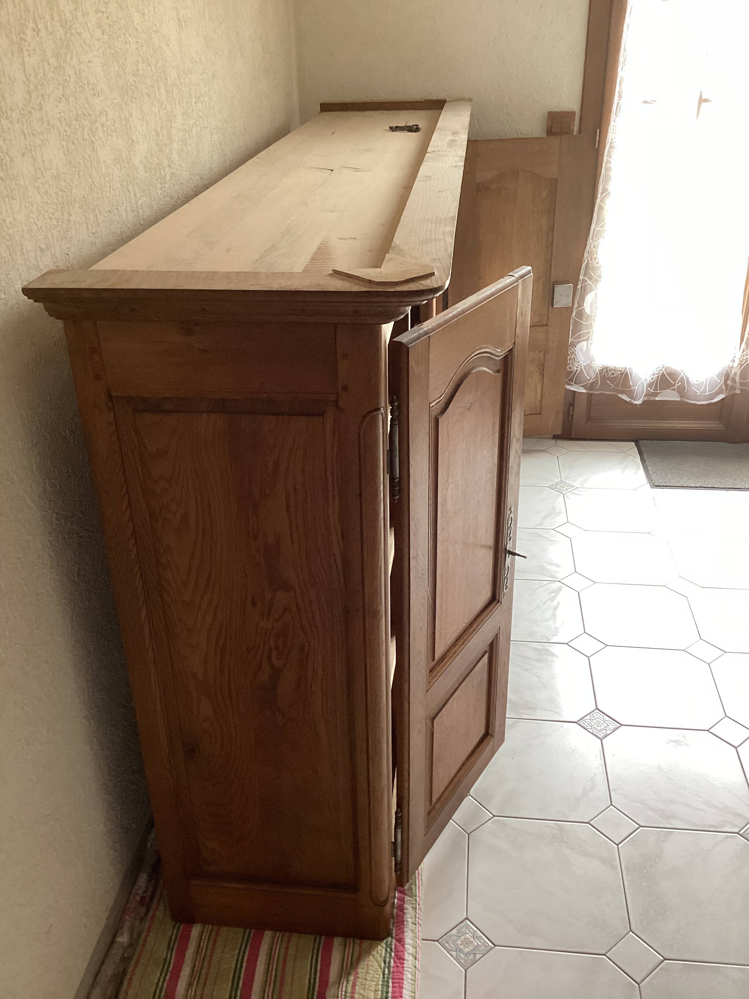 Upper part of a rustic solid oak dresser with its cornice.