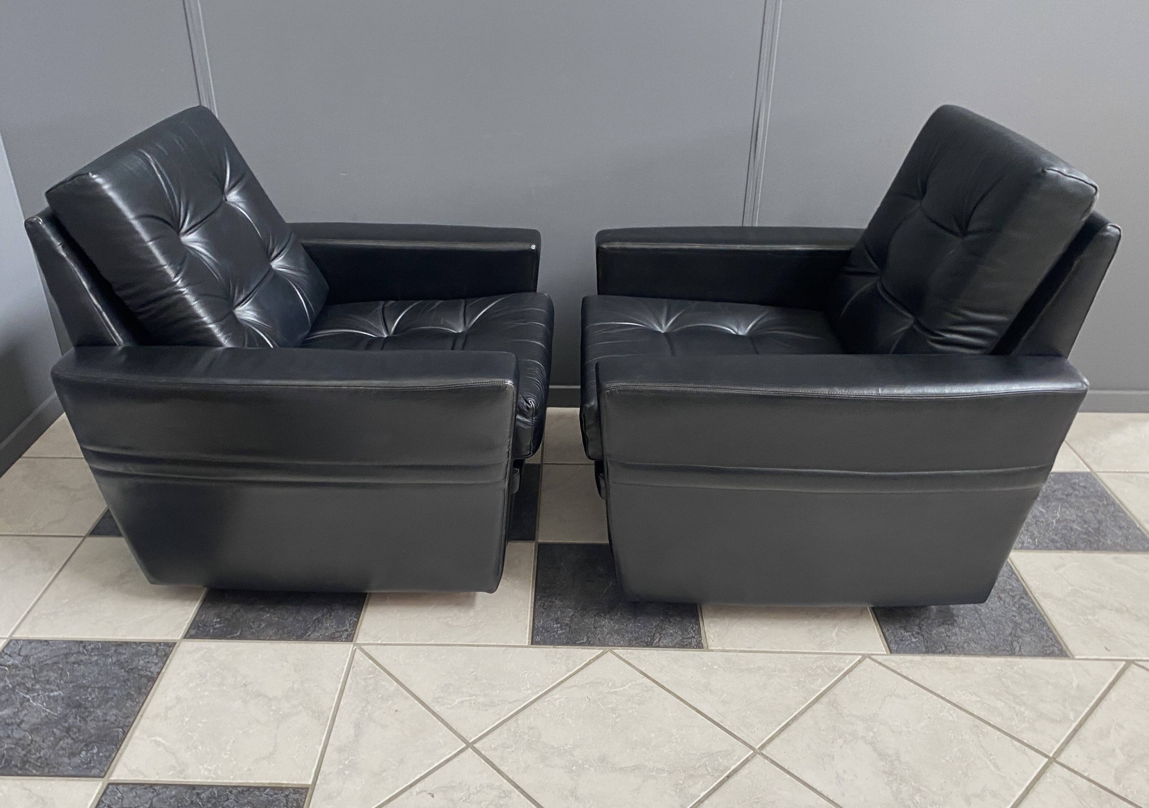 2 Black leather arm chairs 1960s on wheels