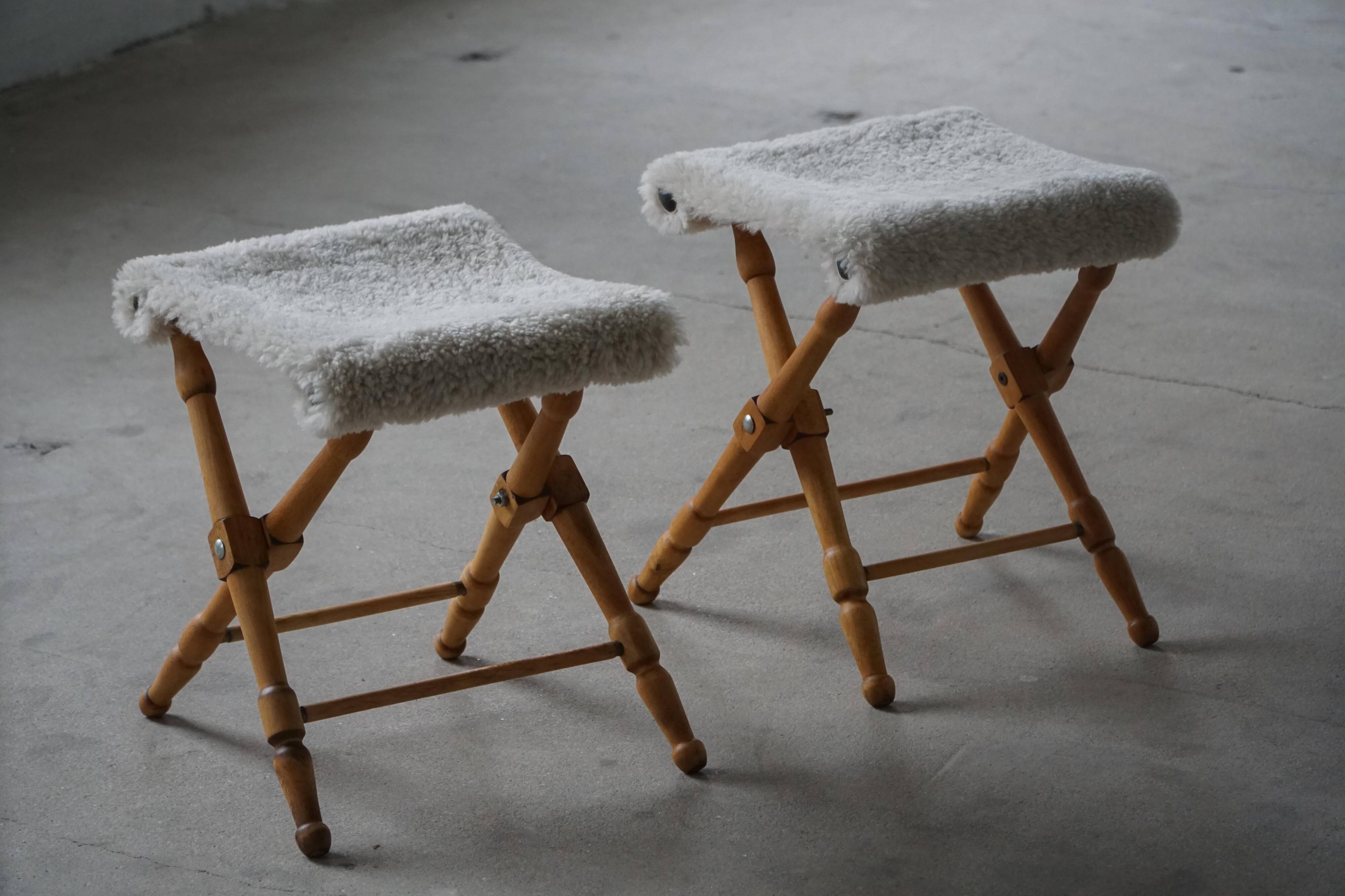Pair of Danish mid-century folding stools with sheepskin upholstery, 1960.