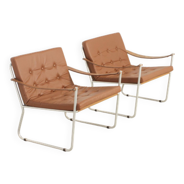 Pair of safari-style armchairs with leather strap armrests, 1960.