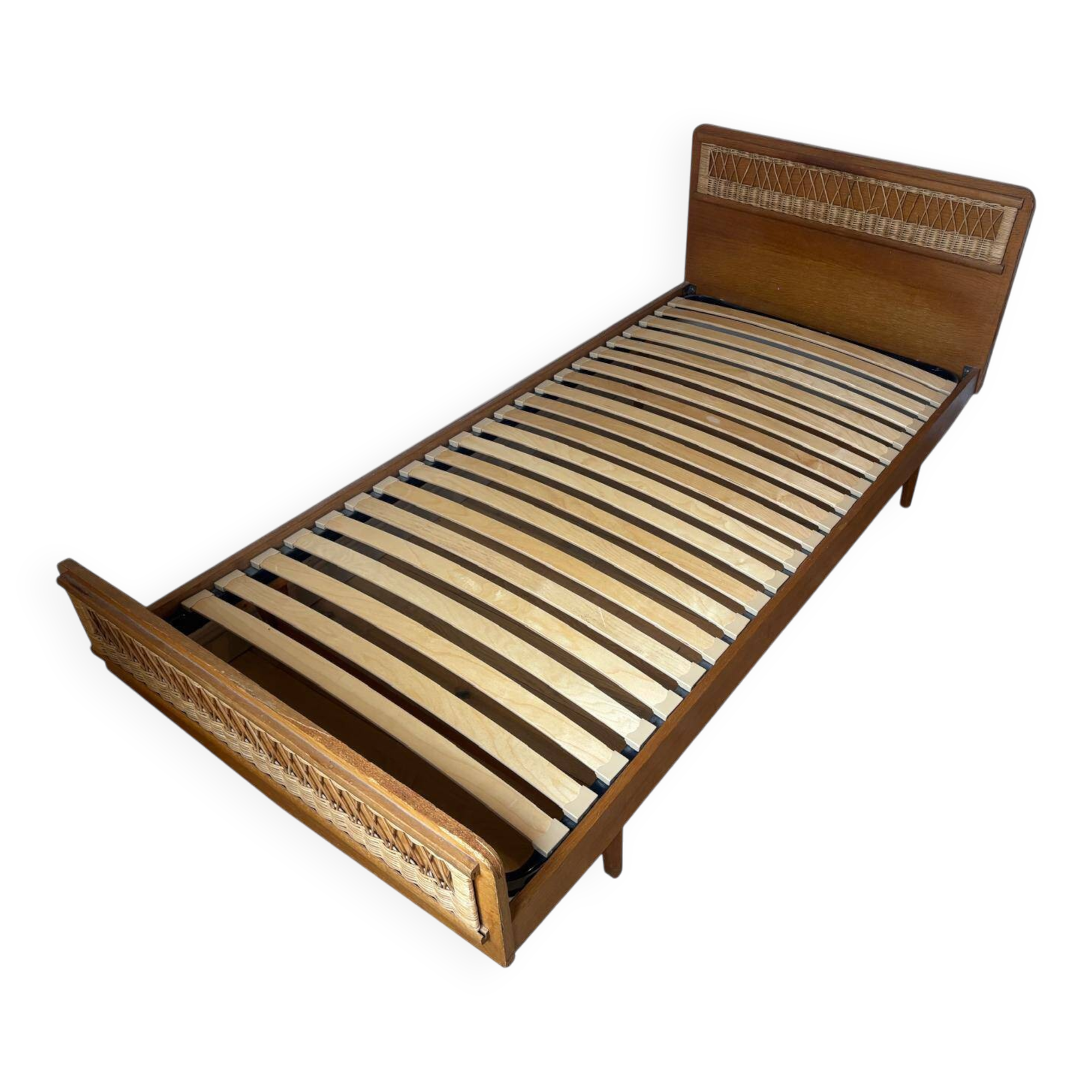 Vintage single bed made of rattan from the 1970s with a mattress.