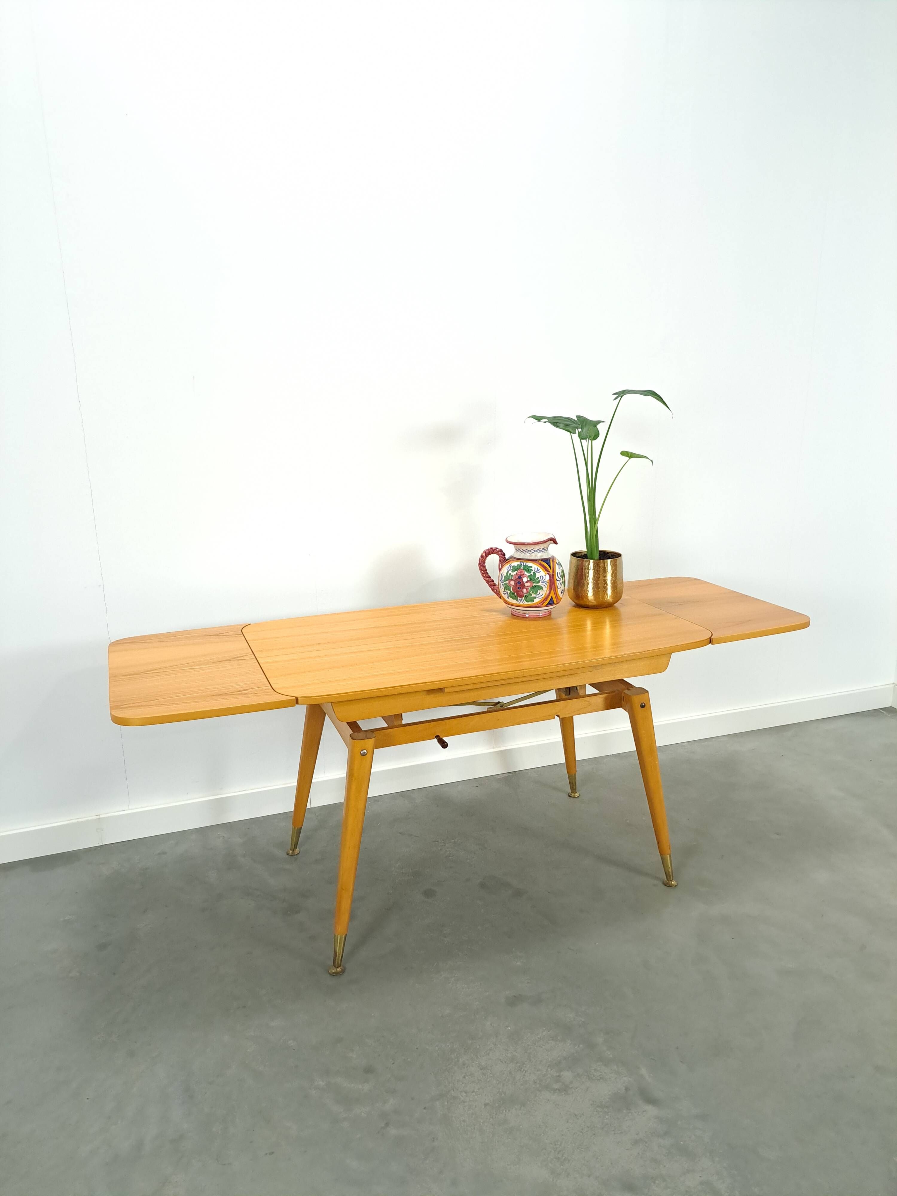 Vintage veneer table with pretty angular legs and brass at the base of the legs.