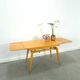 Vintage veneer table with pretty angular legs and brass at the base of the legs.