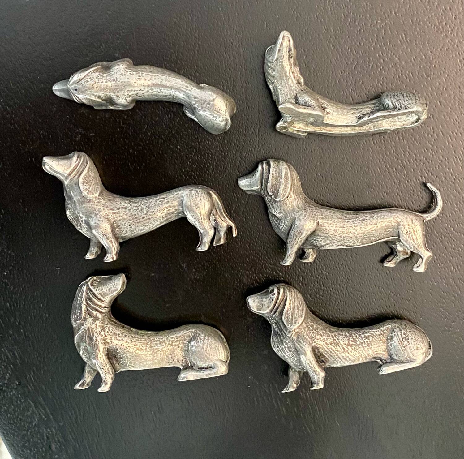 12 old dog-shaped Etains du Manoir knife holders