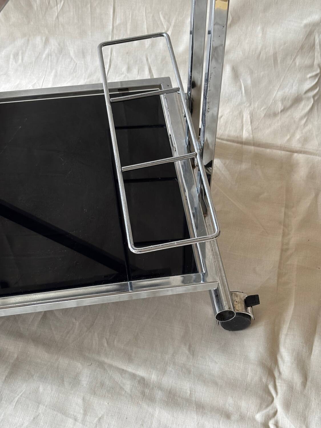 Modernist serving trolley in chromed metal and black smoked glass