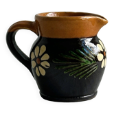 Small Alsatian pitcher in black and brown ceramic, decorated with hand-painted floral motifs.