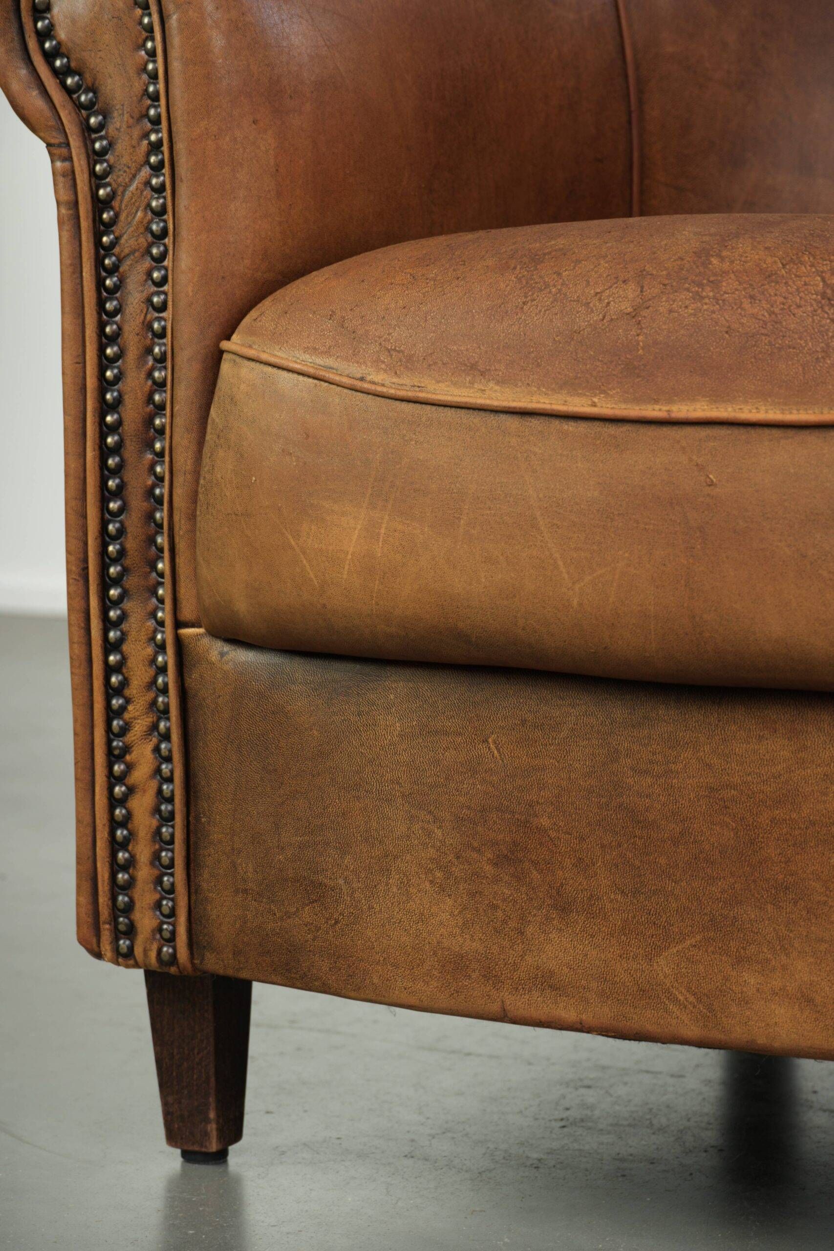 Aged sheepskin clubchair with beautiful vintage patina and comfortable seat