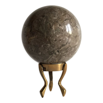 Marble ball paperweight on vintage brass