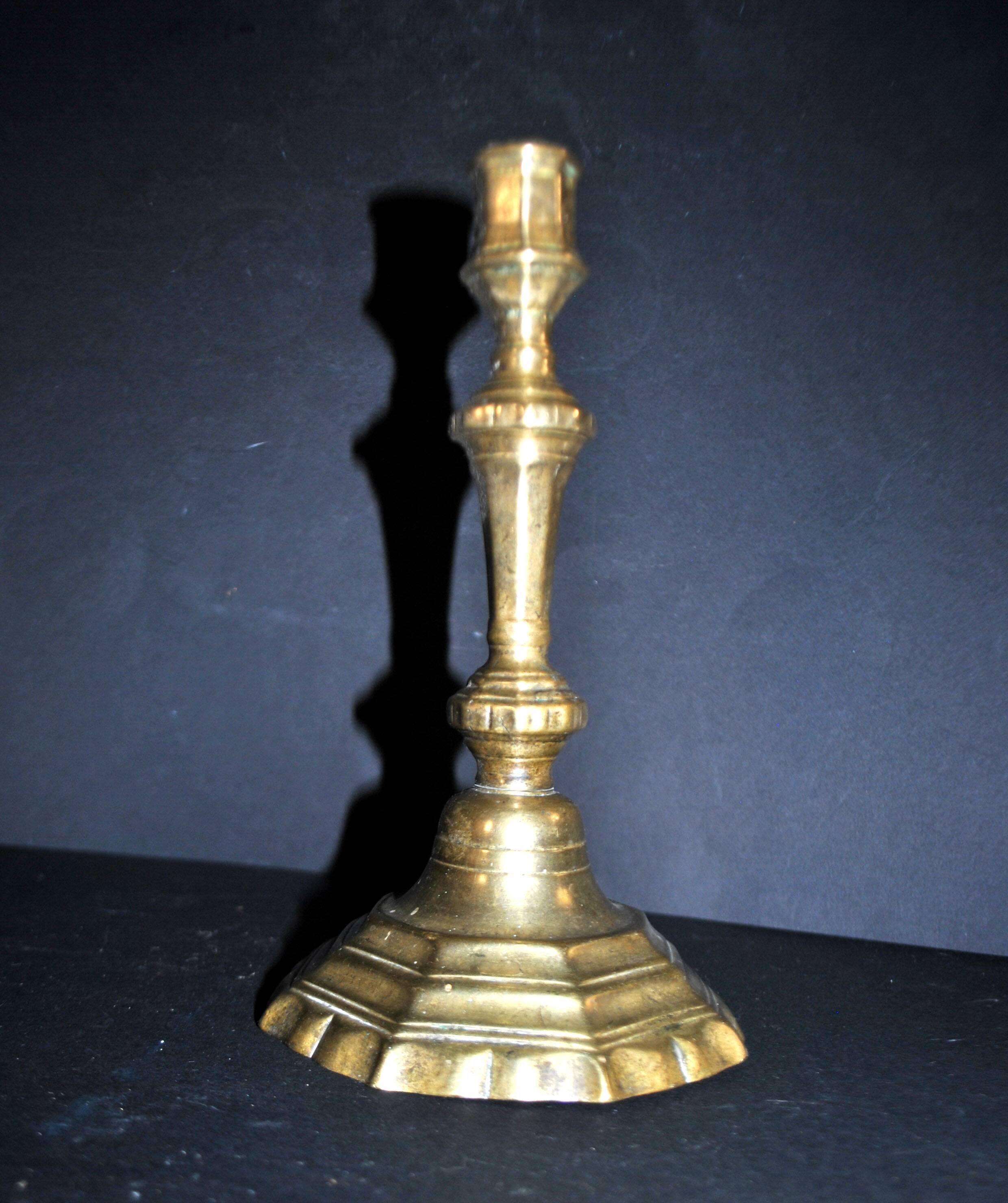 Antique 18th-century octagonal cut-out bronze candlestick in the Louis XIV style.