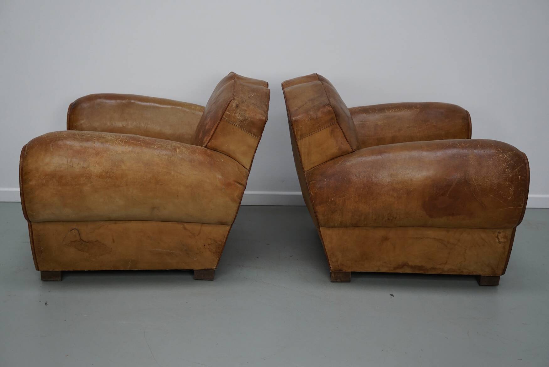 Pair of French club chairs with moustache back in cognac leather, 1940s
