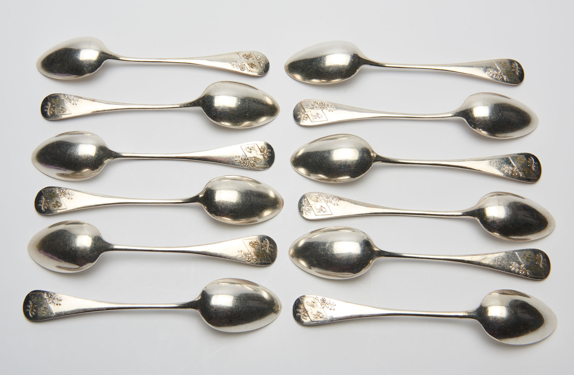 12 small silver metal spoons engraved "FB", early XXth