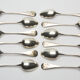 12 small silver metal spoons engraved "FB", early XXth