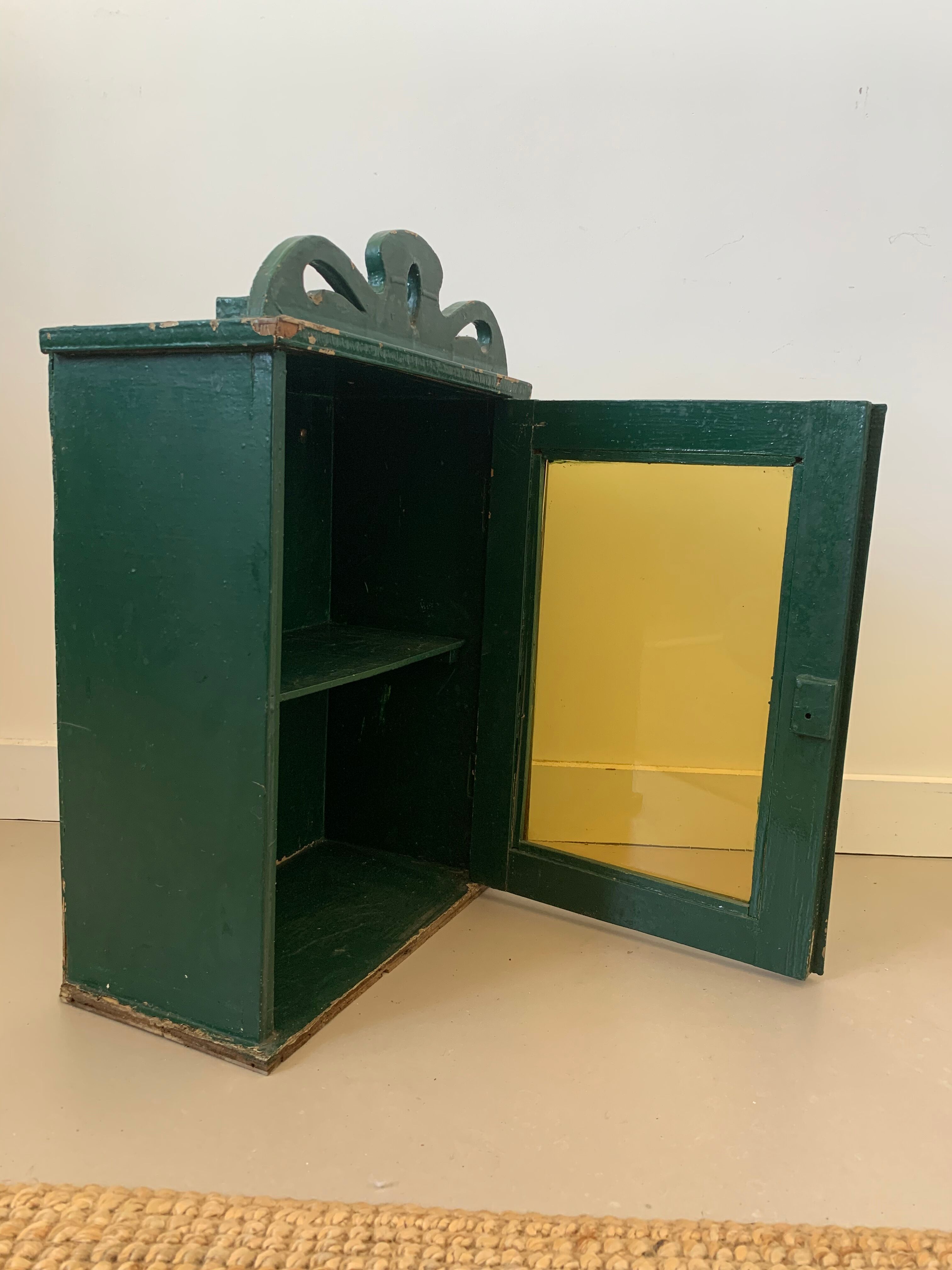 Wall vitrin with pediment