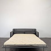 Black leather convertible sofa with goose feather upholstery.