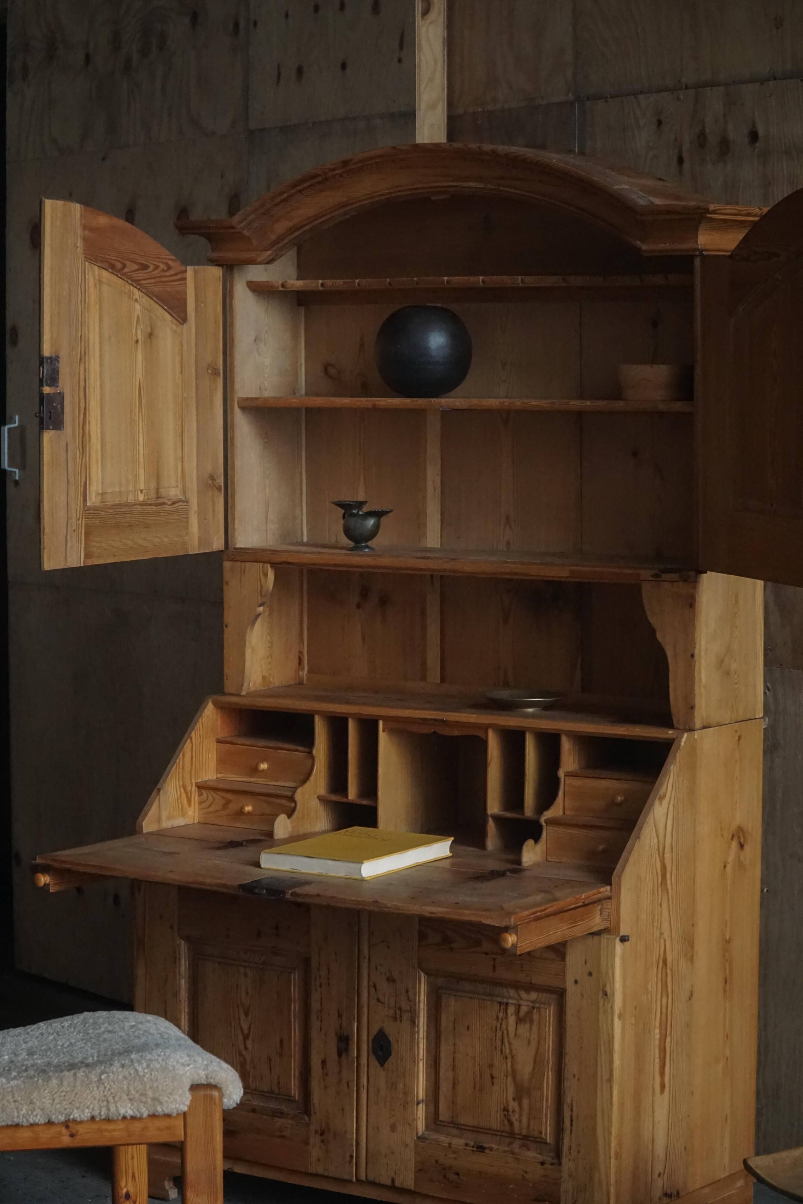 Old Danish secretary in pine with drop-down front and upper cabinet, mid-19th century.