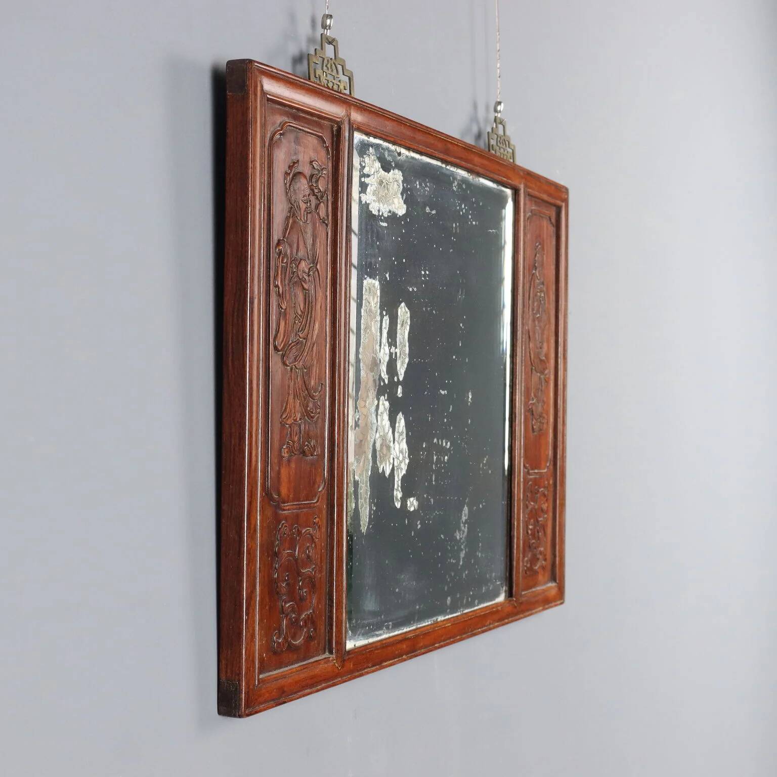 Antique mirror in exotic wood with chinoiserie carvings, 19th century.