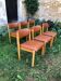 Six wooden and faux leather chairs.