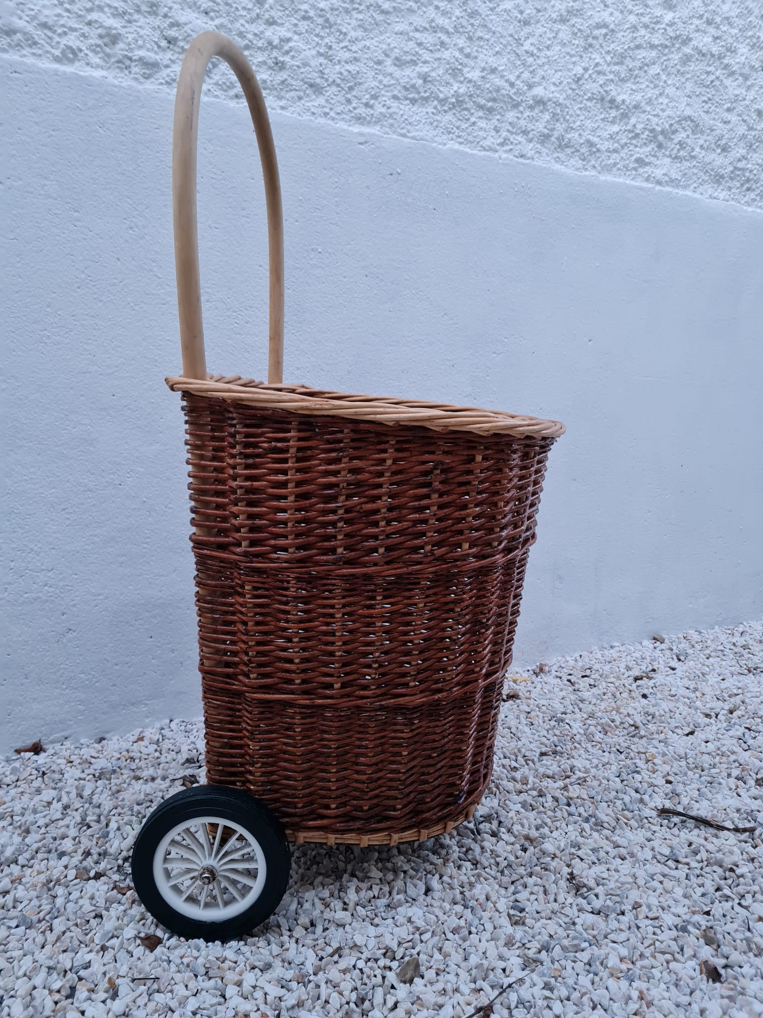 Vintage wicker log basket on vintage wheels