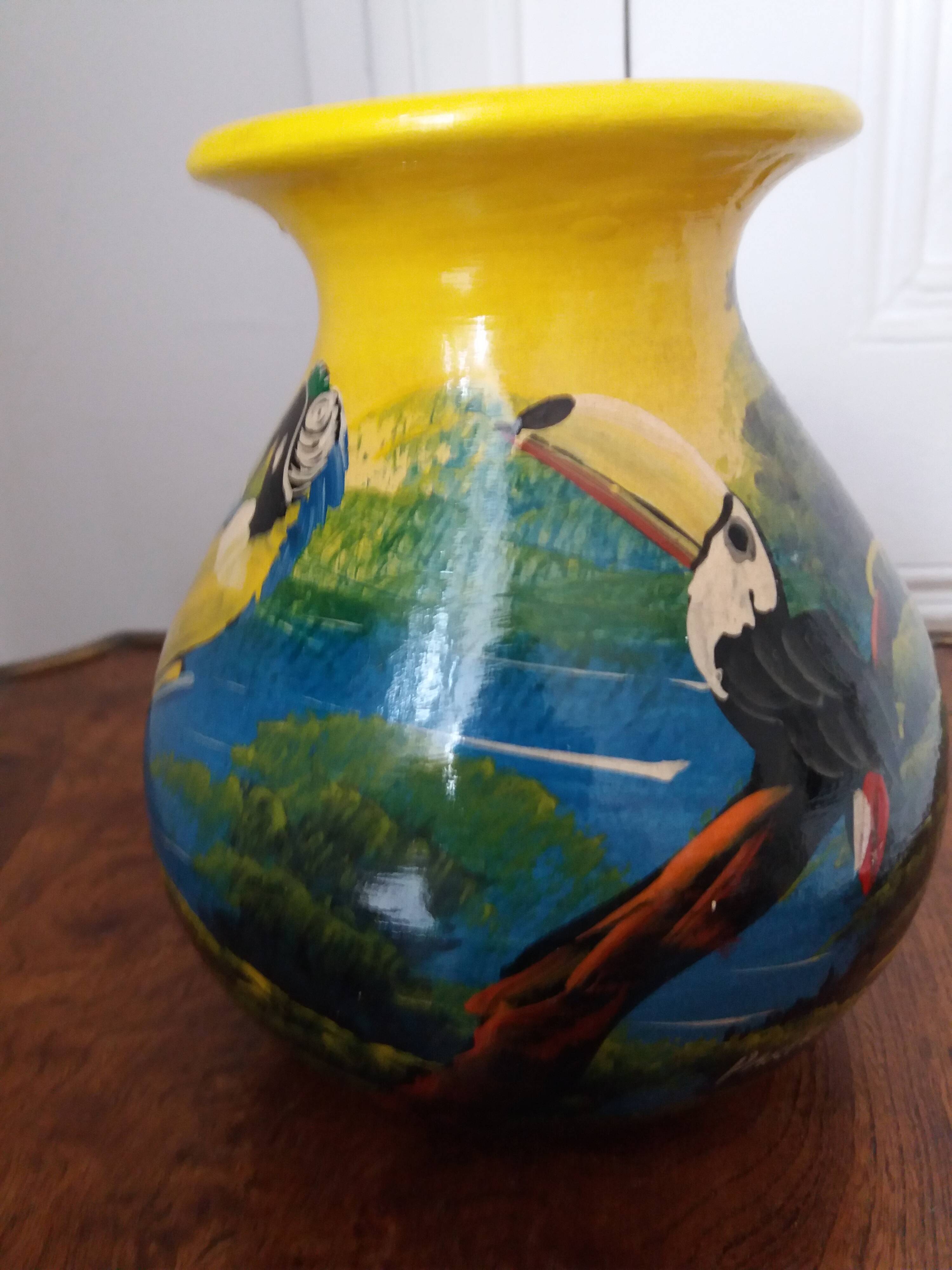 Mexican popular art vase decorated with parrots and toucans.