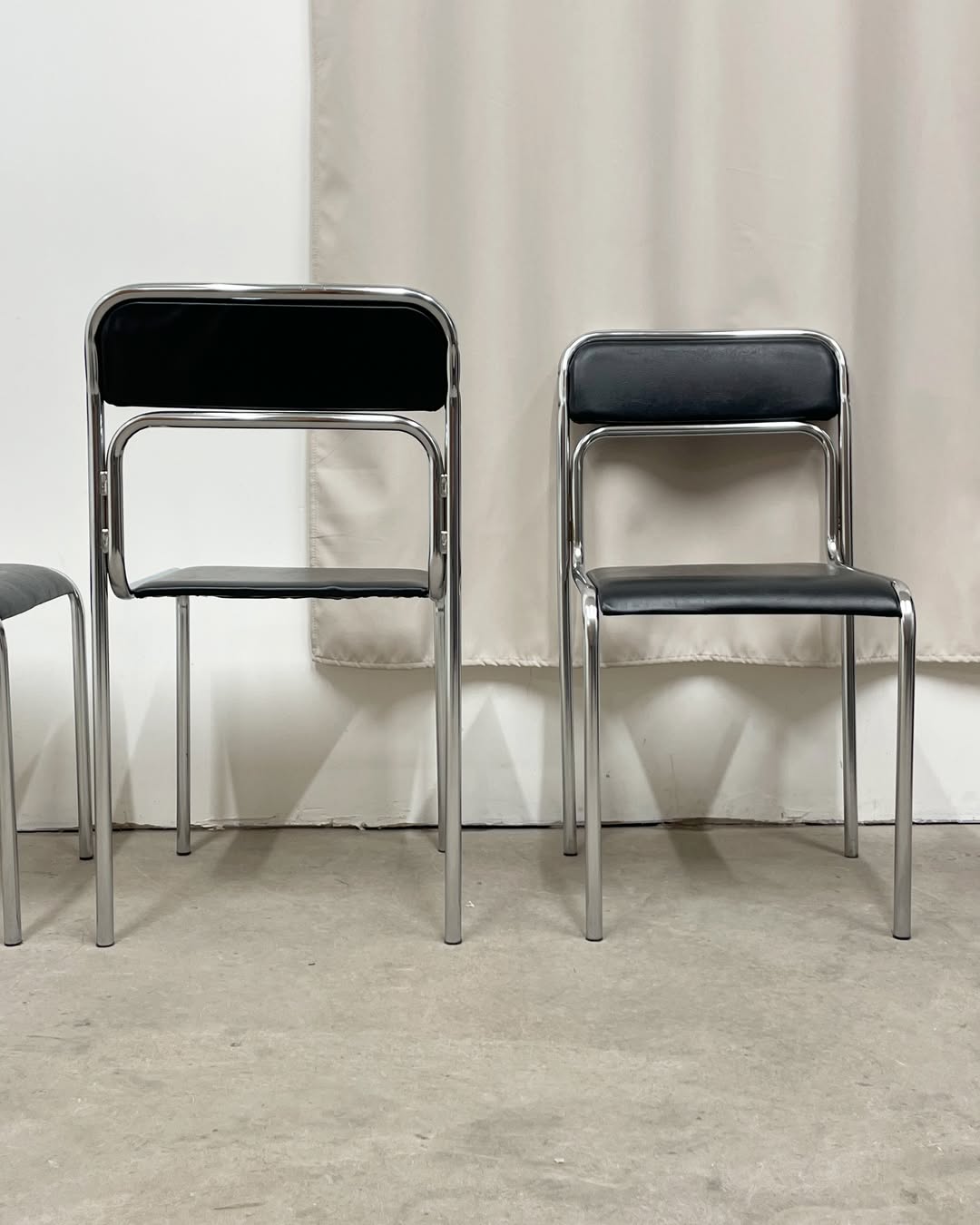 4 chrome metal chairs with black faux leather, 1990
