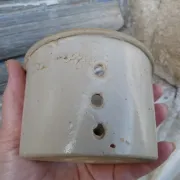 Beige stoneware cheese drainer