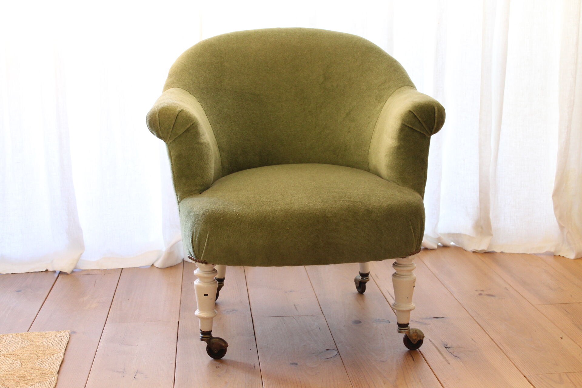 Toad in almond green velvet armchair on castors