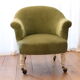 Toad in almond green velvet armchair on castors