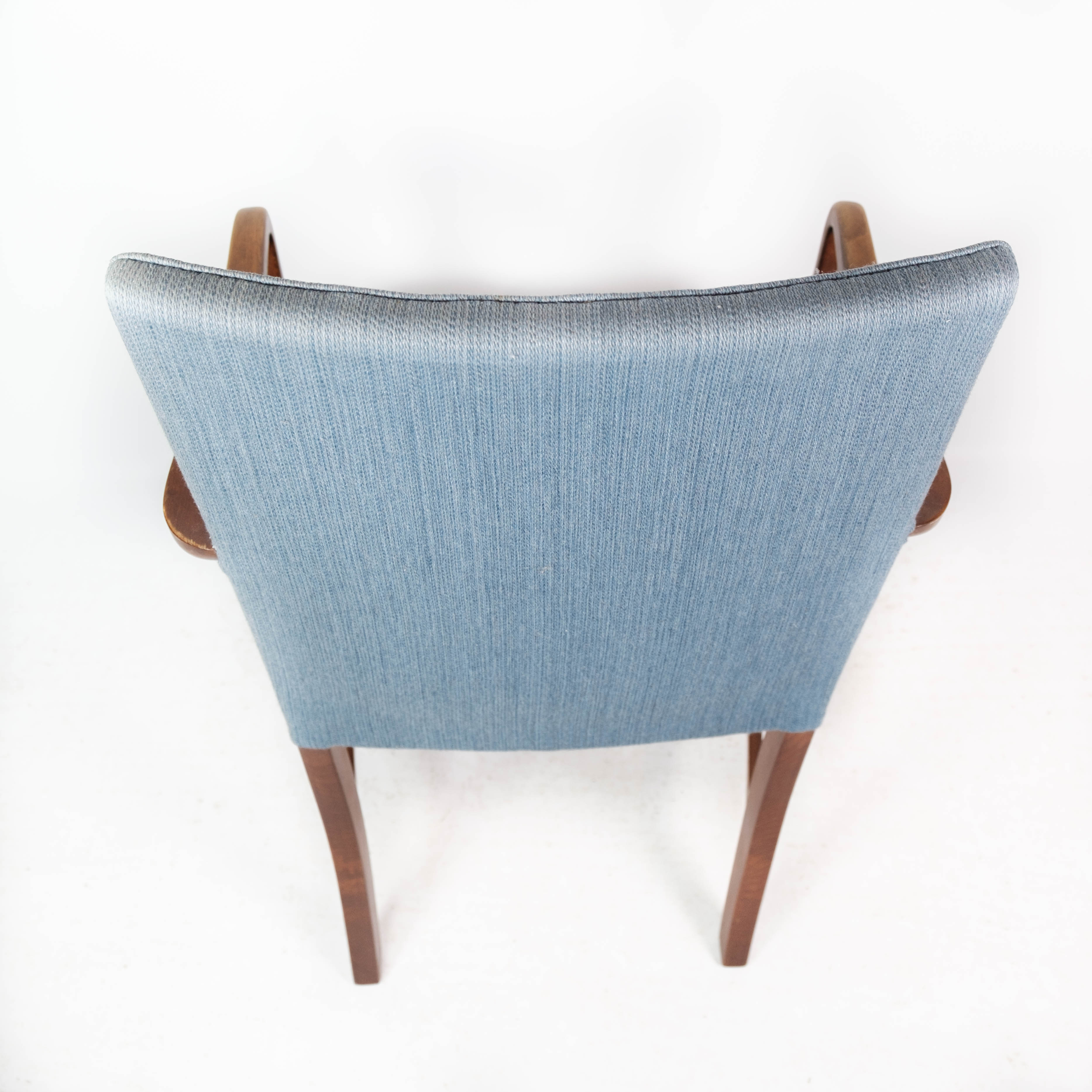 Armchair in mahogany and upholstered with light blue fabric by Fritz Hansen