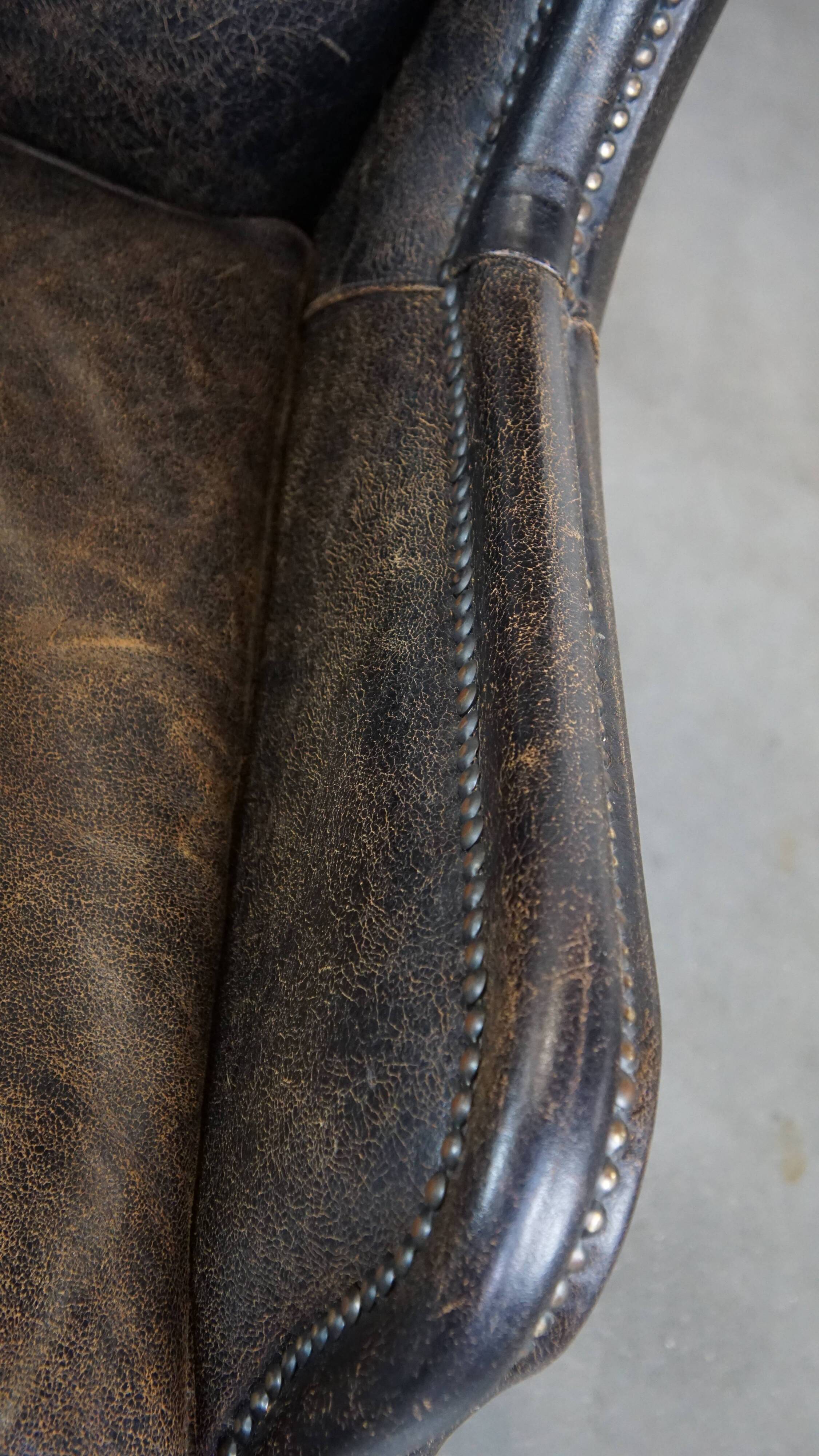 Set of 2 black cow leather armchairs finished with decorative nails, industrial style