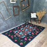 Handwoven floral wool rug, black background with pink roses and geometric design 207x144cm