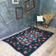 Handwoven floral wool rug, black background with pink roses and geometric design 207x144cm