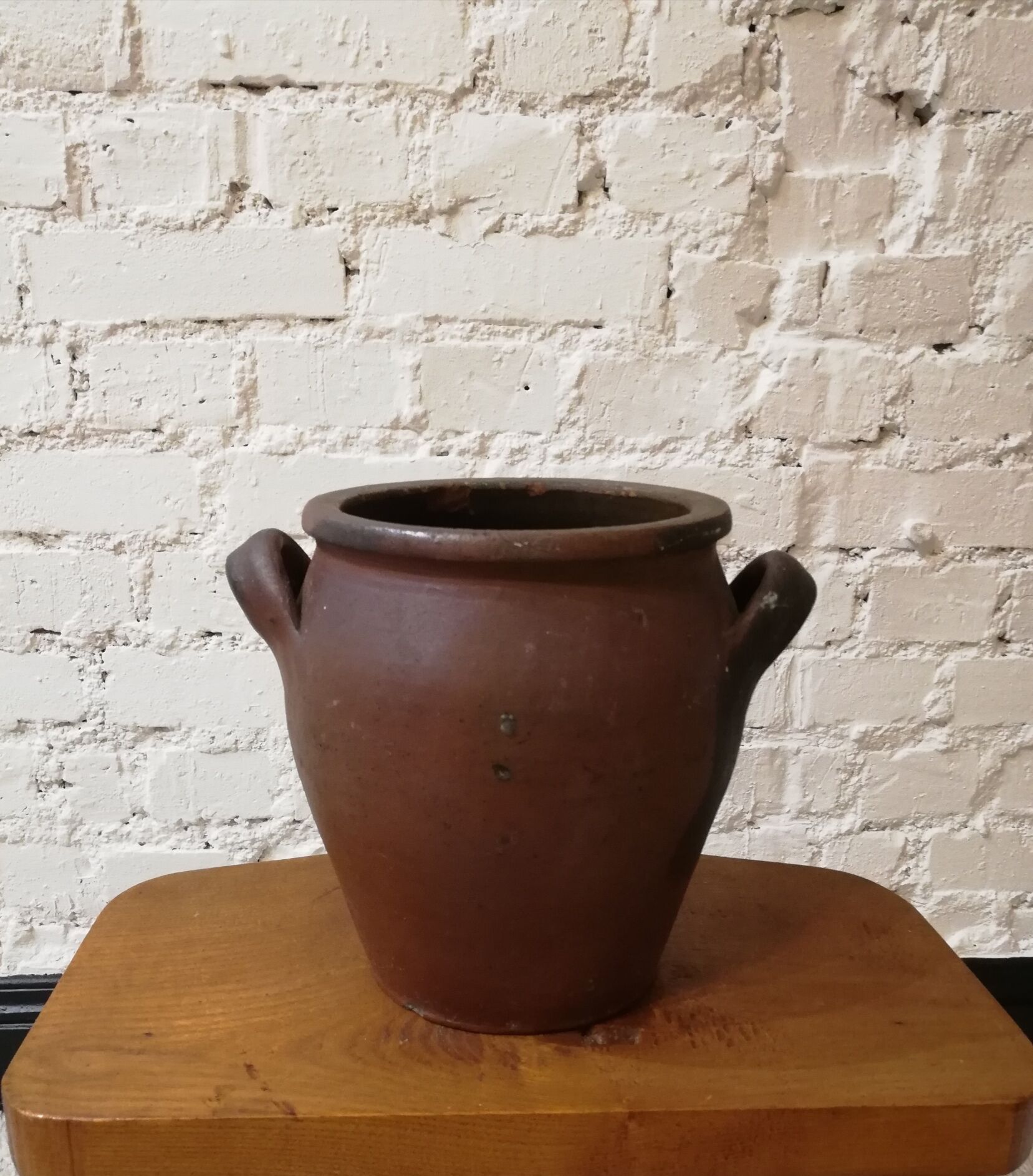 Old red and black terracotta grease pot