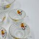 Vintage glass fruit salad serving set with a pansy design.