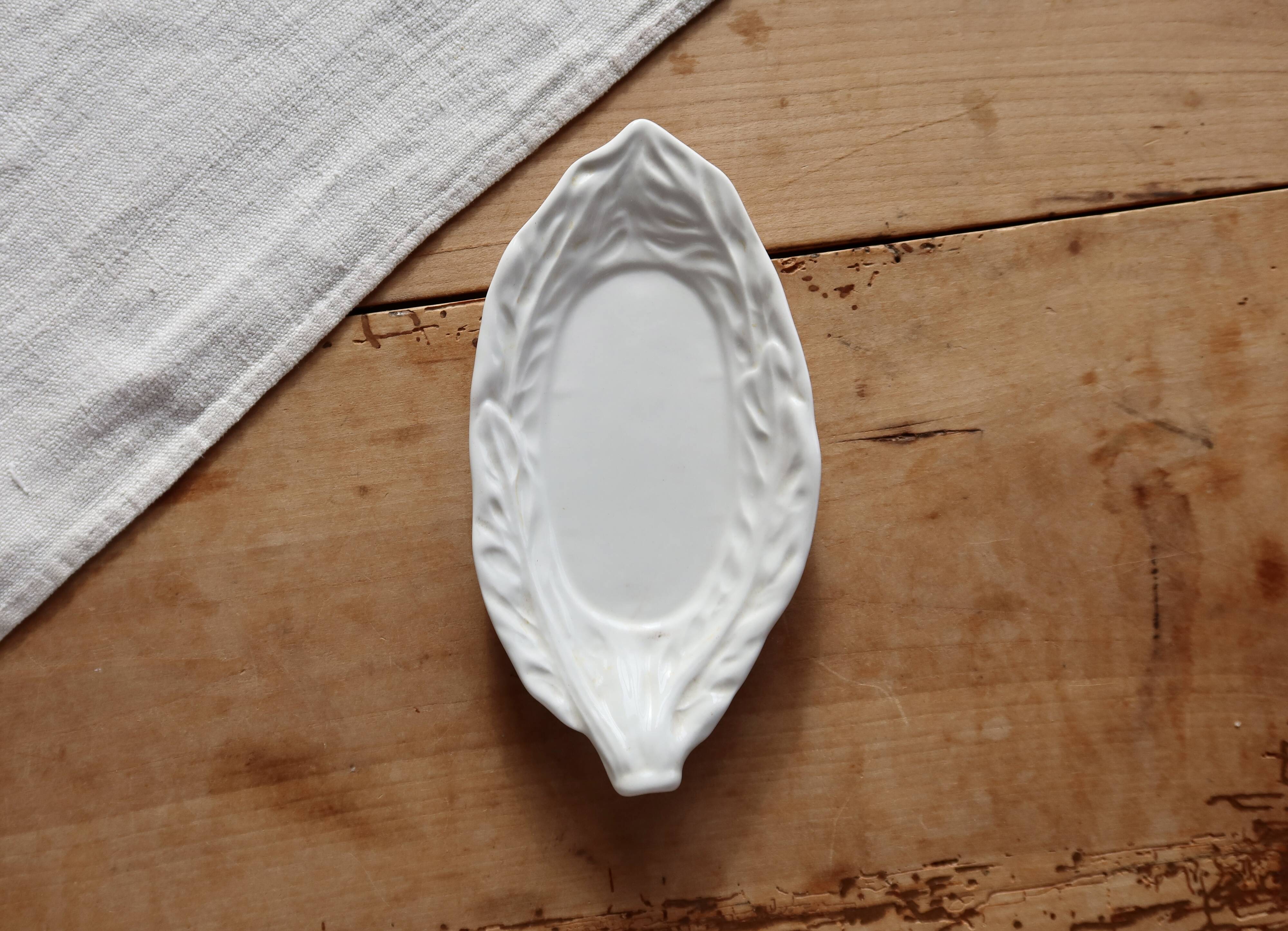 Antique leaf-shaped white English slipware dish.