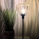 Table lamp with an antique star-shaped globe and a black base