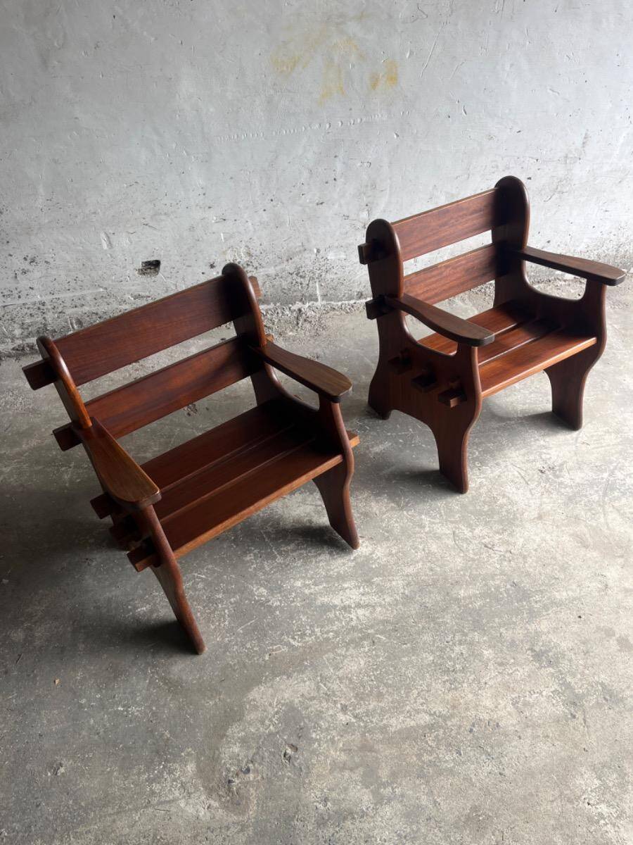 Set of two dark brown solid wood brutalist sculptural chairs with carved details