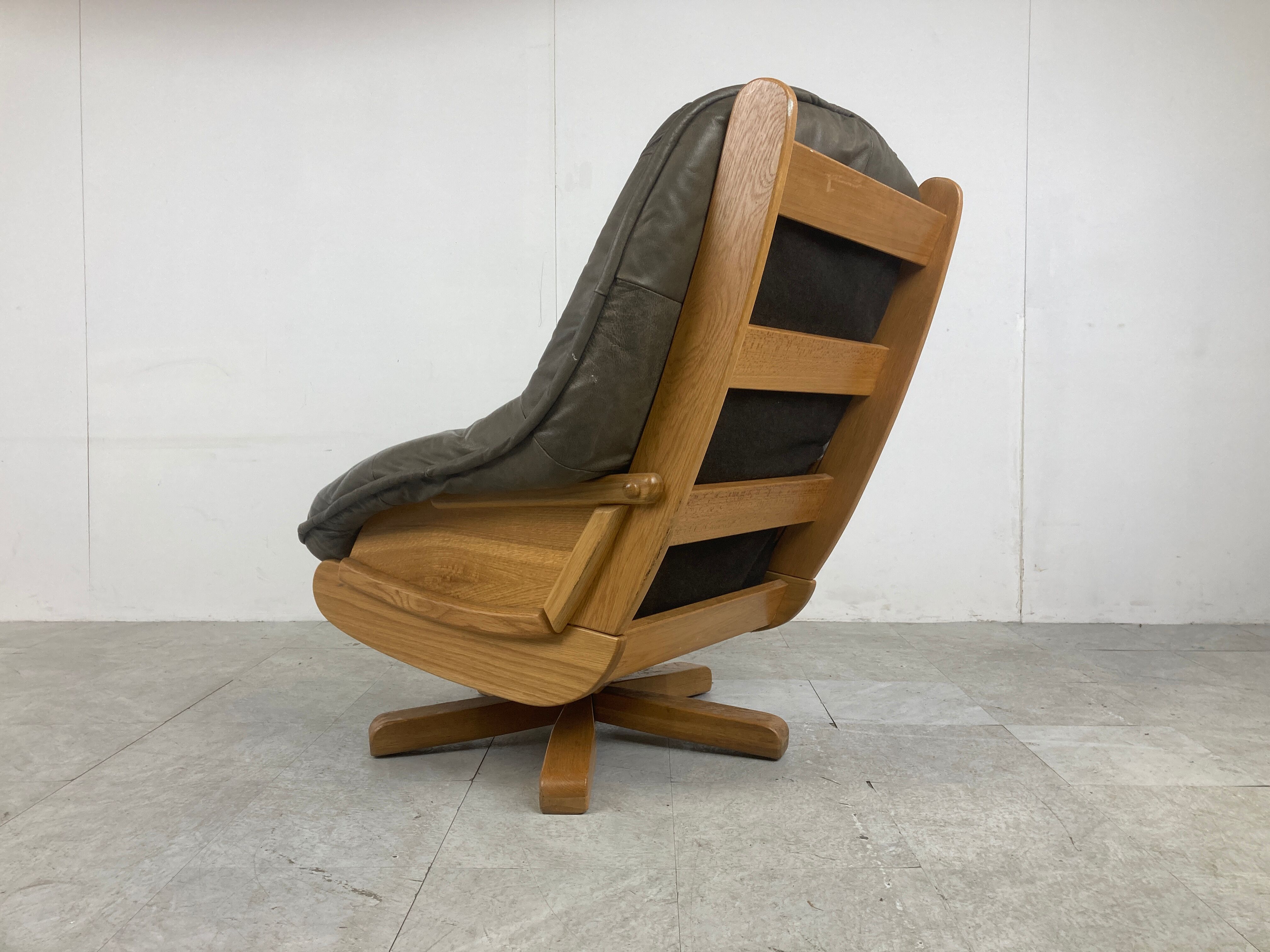 Brutalist oak and leather swivel chair, 1970s
