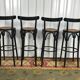 Suite de 4 tabourets de bar en cannage et bois noirci