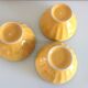 Suite of three yellow ribbed bowls with blue / vintage 70s border