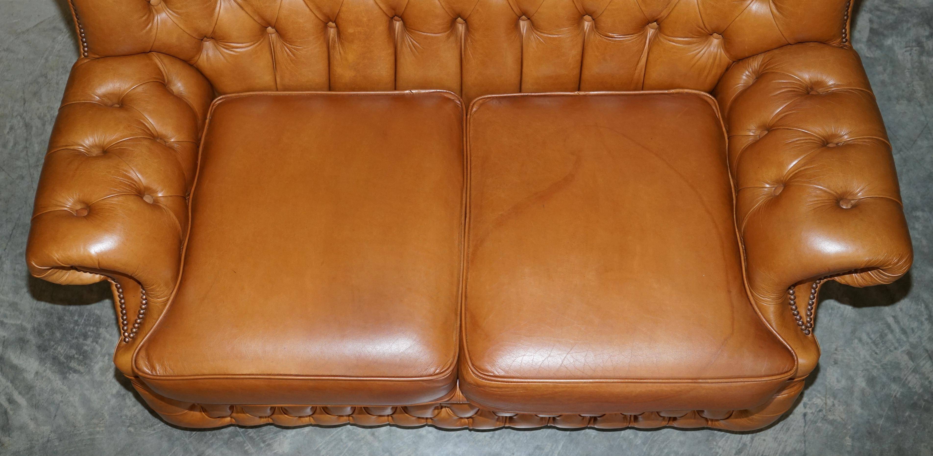Small Chesterfield leather sofa with a high back.