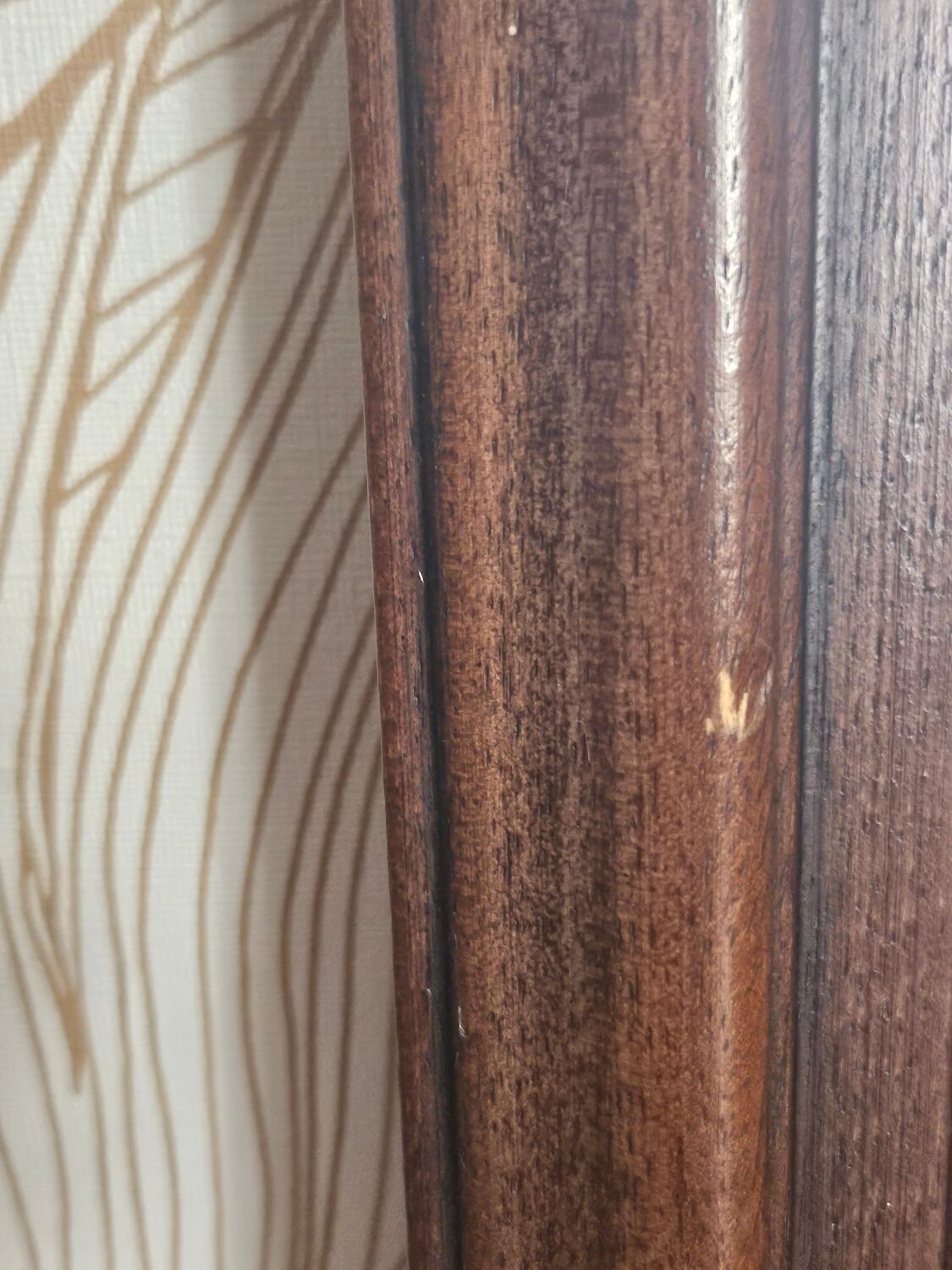 Beveled glass mirror in its wooden frame