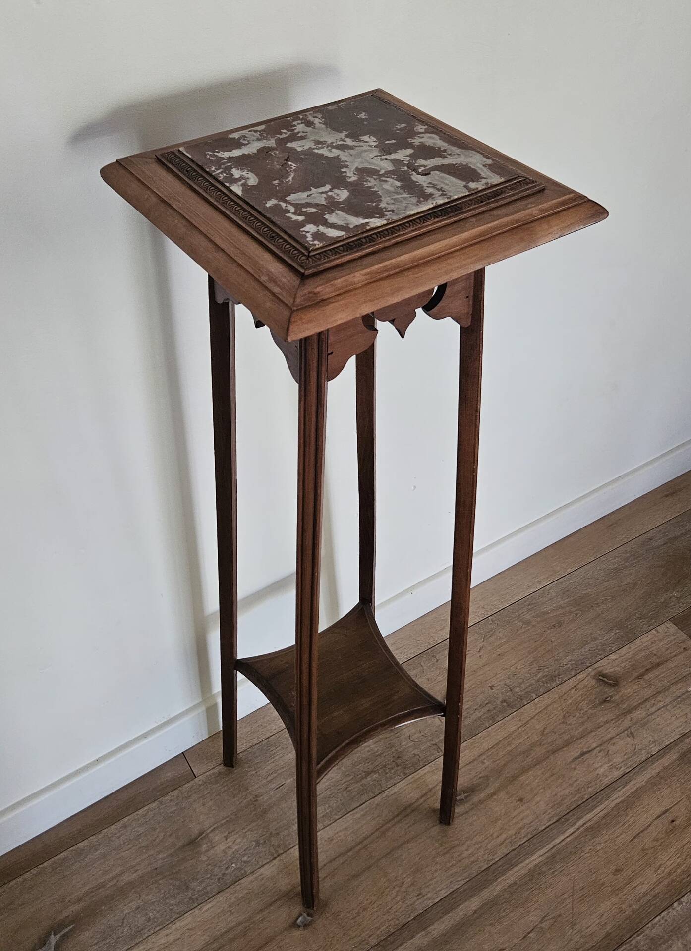 High plant stand in carved wood and Art Nouveau marble.