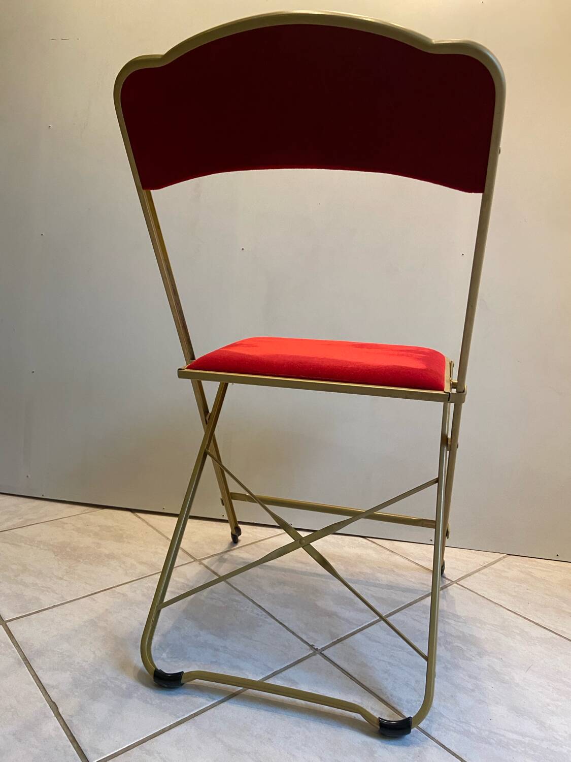 Velvet folding chair with gold metal.