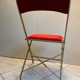 Velvet folding chair with gold metal.