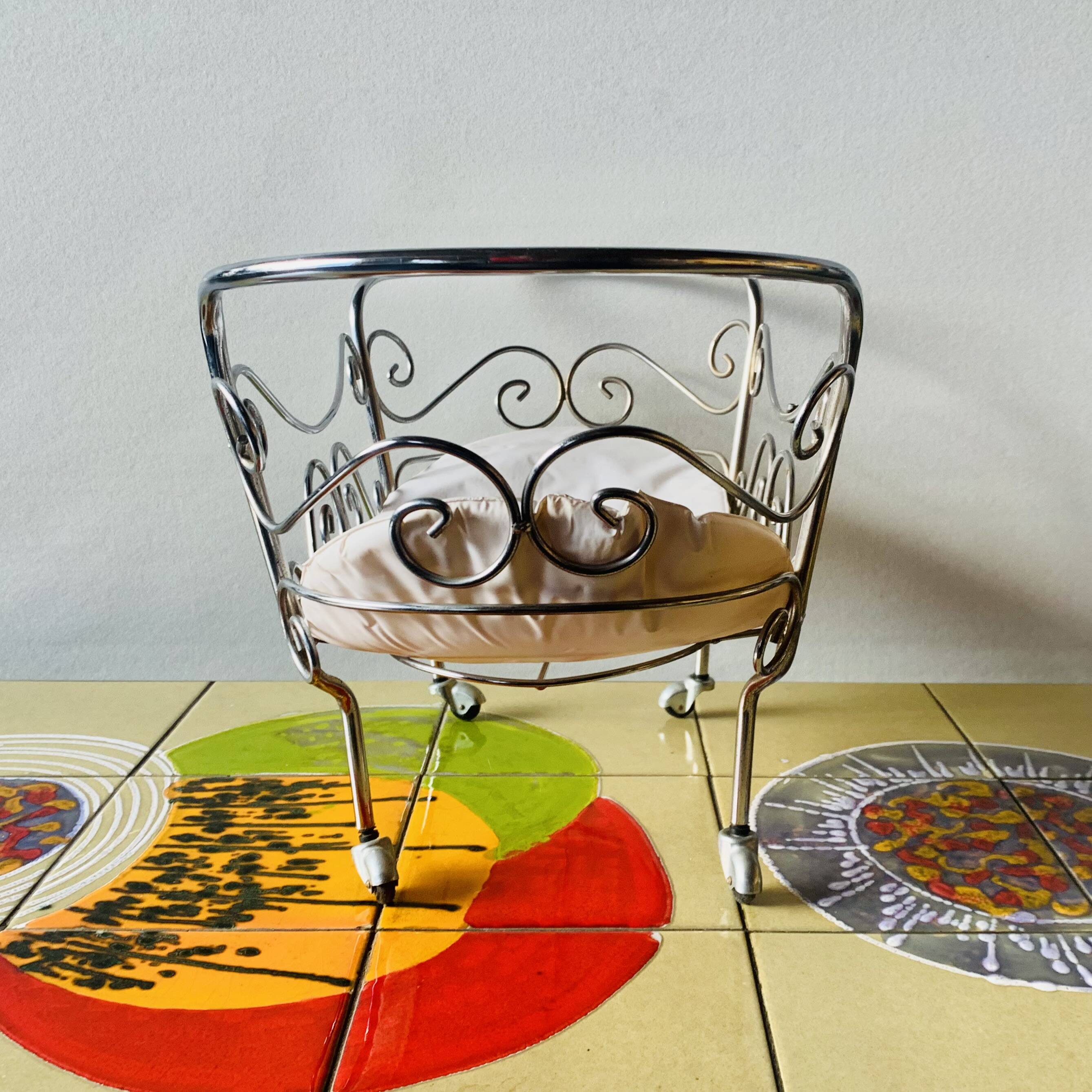 Metal doll's bed on vintage casters