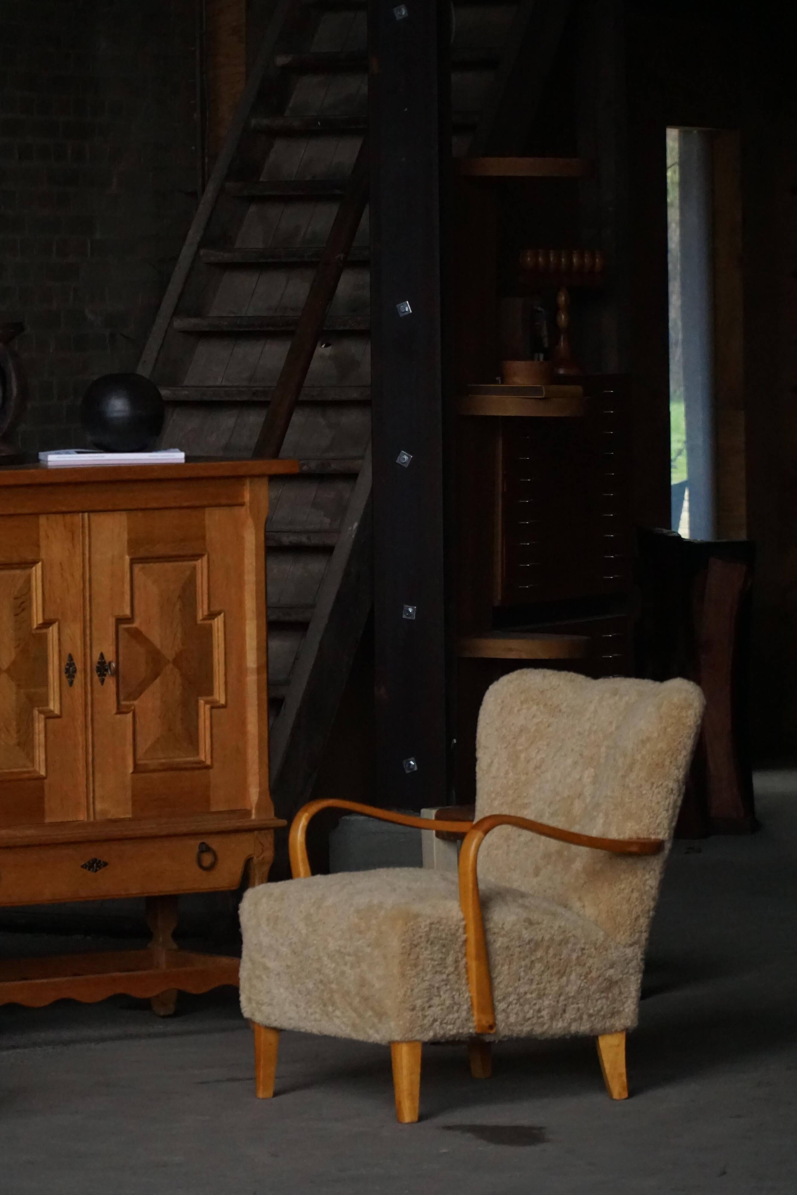 Pair of Mid Century Modern Swedish lounge chairs in birch and lamb's wool, 1960s.