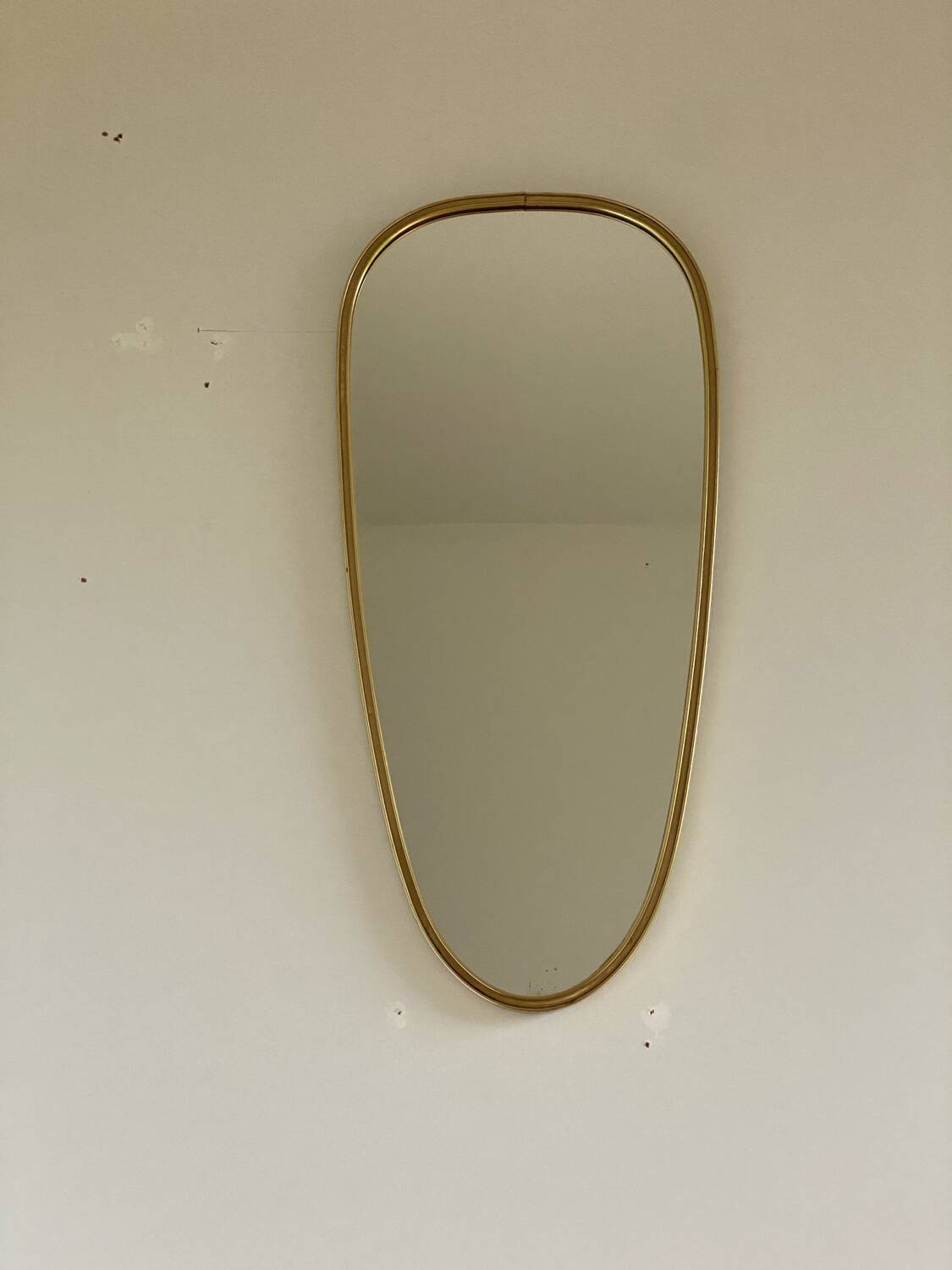 Vintage brass mirror in rear-view mirror shape